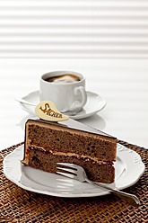 Plate of Sachertorte slice with coffee, close up - CSF016287