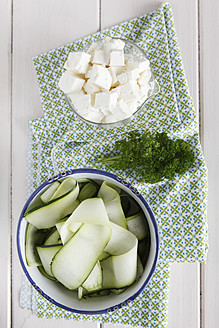 Schalen mit Zucchinischeiben und Feta-Käse mit Petersilie auf dem Holztisch - EVGF000050