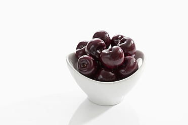 Bowl of cherries on white background, close up - CSF016494