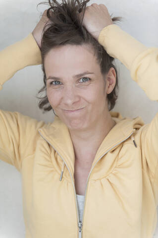 Germany, North Rhine Westphalia, Bonn, Portrait of woman tearing her hair stock photo