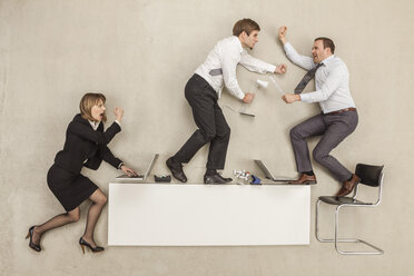 Business people fighting on office desk - BAEF000412