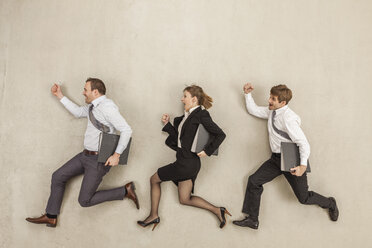 Business people with files running behind each other - BAEF000425