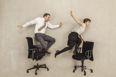 Business people skating on office chair - BAEF000517