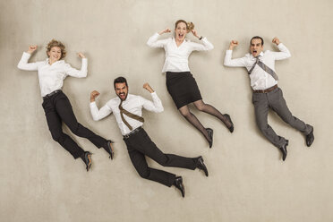 Business people jumping in office - BAEF000533