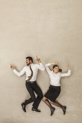 Business people dancing against beige background - BAEF000536