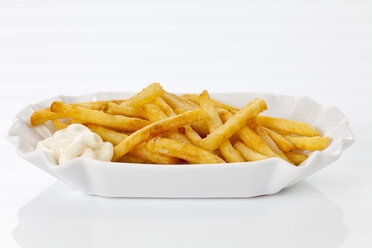 French fries with mayonnaise on plate, close up - CSF016674