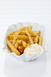 French fries with mayonnaise on plate, close up - CSF016675