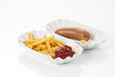 Bockwurst with mustard, french fries, tomato ketchup and mayonnaise on plate, close up - CSF016678