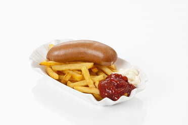 Bockwurst with mustard, french fries, tomato ketchup and mayonnaise on plate, close up - CSF016679