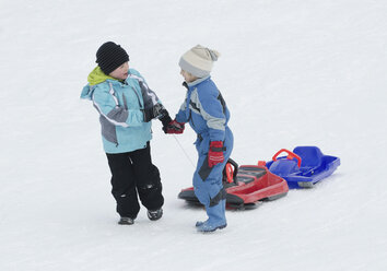 Austria, Boys pulling sledge through snow - CWF000008