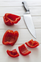 Chopped bell pepper with kitchen knife on wooden table, close up - EVGF000066