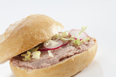 Sandwich of bread roll with liver sausage on white background, close up - CSF017259