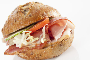 Sandwich of grain bread roll with bacon on white background, close up - CSF017260