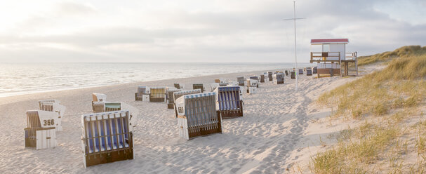 Germany, View of empty beach with roofed wicker beach chairs on Sylt island - ATA000007