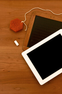 Old chalk board with digital tablet on wooden tablet - JEDF000010