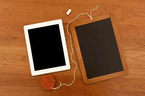 Old chalk board with digital tablet on wooden tablet - JEDF000011