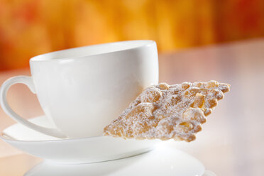 Tea cup and saucer with mutzen pastry, close up - CSF017340