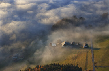 Austria, Salzkammergut, View of farmhouse covered with fog - WW002701