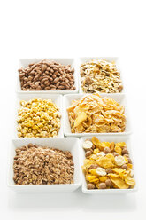 Variety of cereals in bowl on white background, close up - MAEF005974