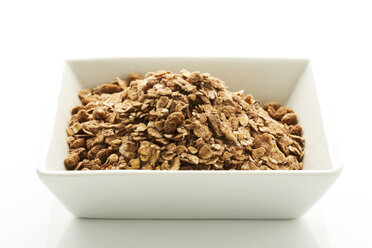 Bowl of chocolate chips on white background, close up - MAEF005977