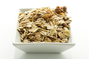 Bowl of muesli on white background, close up - MAEF005982