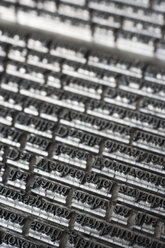 Germany, Bavaria, Continous text of typesetting in shop, close up - TCF003364