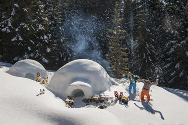 Austria, Salzburg, Couple playing with snow near igloo - HHF004552