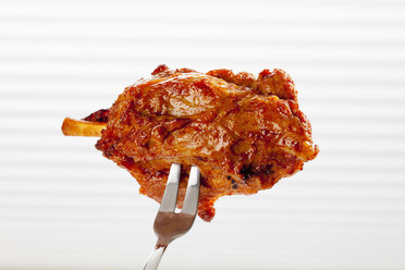 Pork knuckle on fork, close up - CSF017600