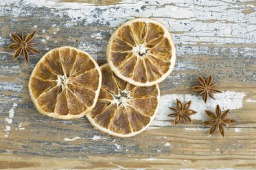 Dried orange slices and star anises on wooden table - AS004855