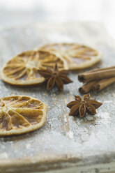 Dried orange slices with star anises and cinnamon sticks, close up - AS004857