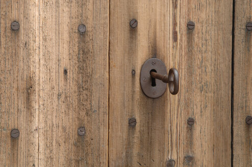 Germany, Wooden door with key in keyhole, close up - ASF004861