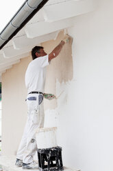 Europe, Germany, Rhineland Palatinate, Man plastering house wall - CSF017674