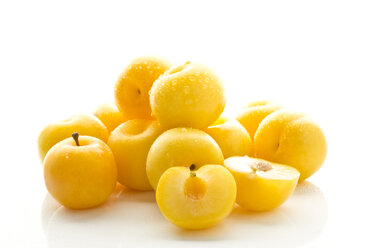 Yellow plums on white background, close up - MAEF006103