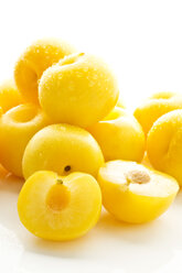 Yellow plums on white background, close up - MAEF006104