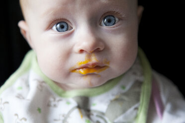 Portrait of baby boy against black background, close up - GA000096