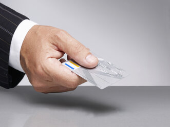 Businessman holding credit card for paying - BSCF000240