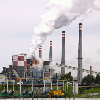 Spain, Avila, Steelworks with smoking industrial chimneys - BSC000243