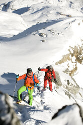 Austria, Men skiing on mountain at Salzburger Land - RN001178