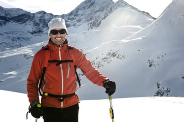 Österreich, Mann beim Skifahren am Berg im Salzburger Land, lächelnd - RN001184