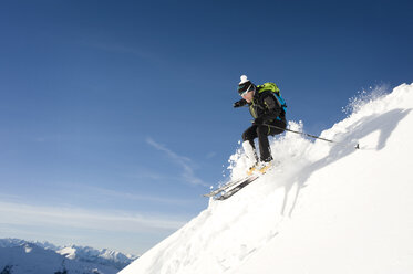 Austria, Man skiing on mountain at Alpbachtal - RN001167