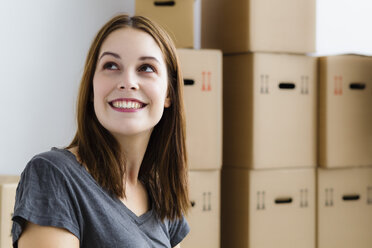 Germany, Munich, Young woman looking up, smiling - SPOF000264