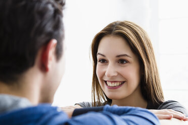 Germany, Munich, Young couple looking at each other, smiling - SPOF000267