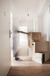 Stack of cardboard boxes in new house - FMKF000532