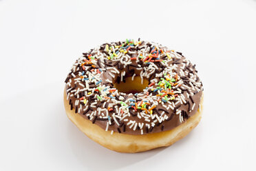 Doughnut topped with chocolate icing and sprinkles, close up - CSF017872