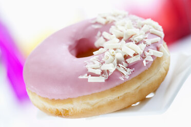 Doughnut topped with pink icing, close up - CSF017895
