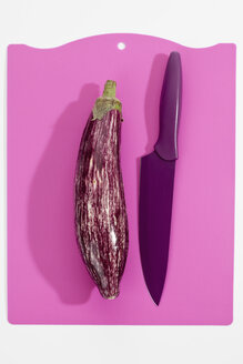 Aubergine mit Messer auf rosa Schneidebrett - CSF017962