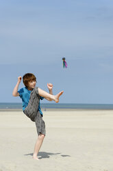 Frankreich, Junge spielt mit Indica am Strand - LBF000019