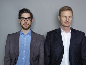 Portrait of businessmen against grey background - STKF000247