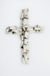 Cross shaped of cigarette stubs on white background - MUF001274