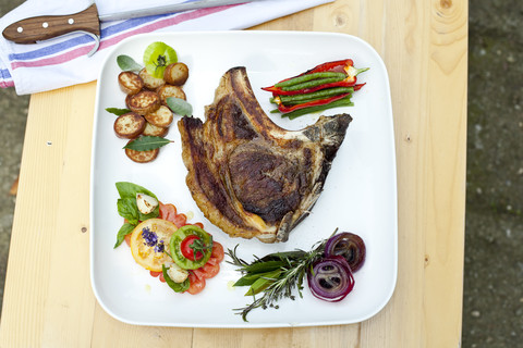 Germany, Dusseldorf, Plate of grilled beef with beans and onions, close up stock photo